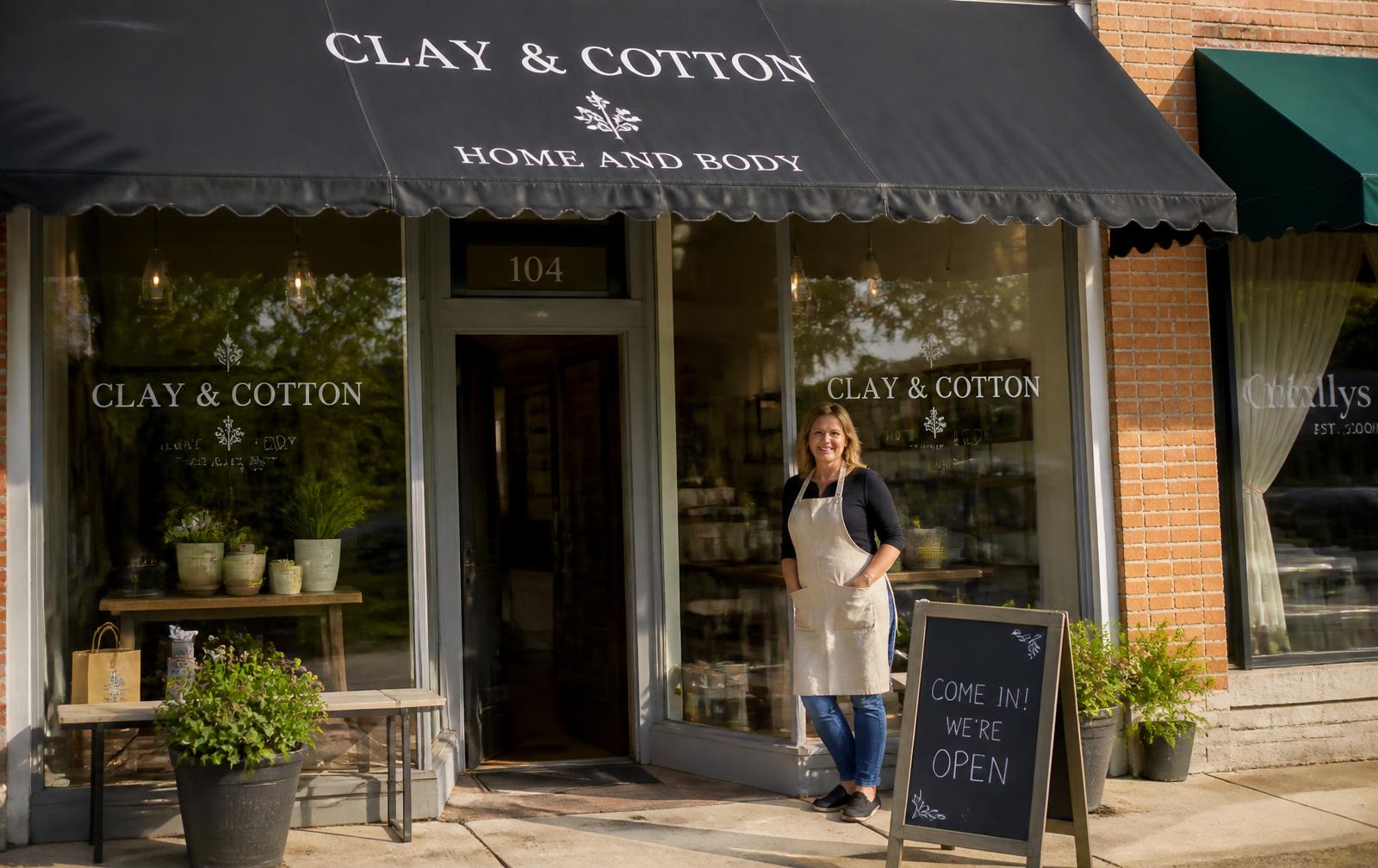 Small business owner outside a main street storefront